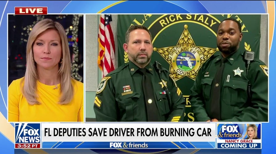 Florida police officers hailed as heroes after rescuing driver from burning car
