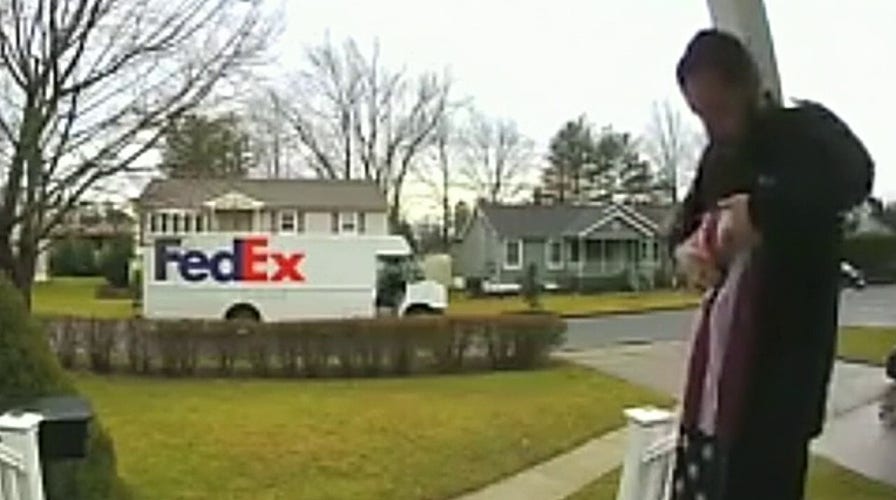 FedEx driver picks up, folds fallen American flag