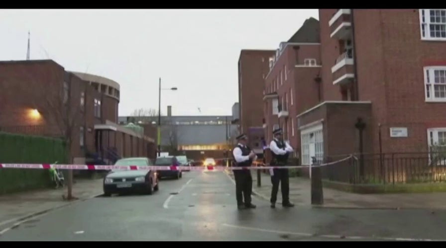 Metropolitan Police secure the scene after a drive by shooting wounded two children and four adults