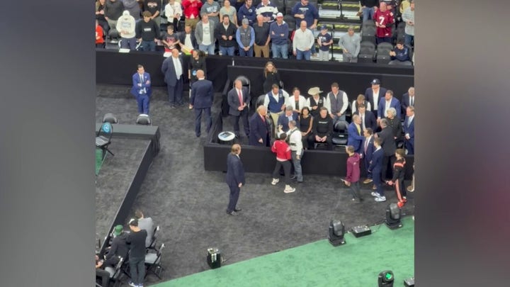 NCAA wrestler shakes hands with Trump, Musk after winning championship bout