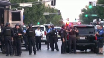 2 St. Louis police officers shot, one critically wounded; suspect in custody after standoff