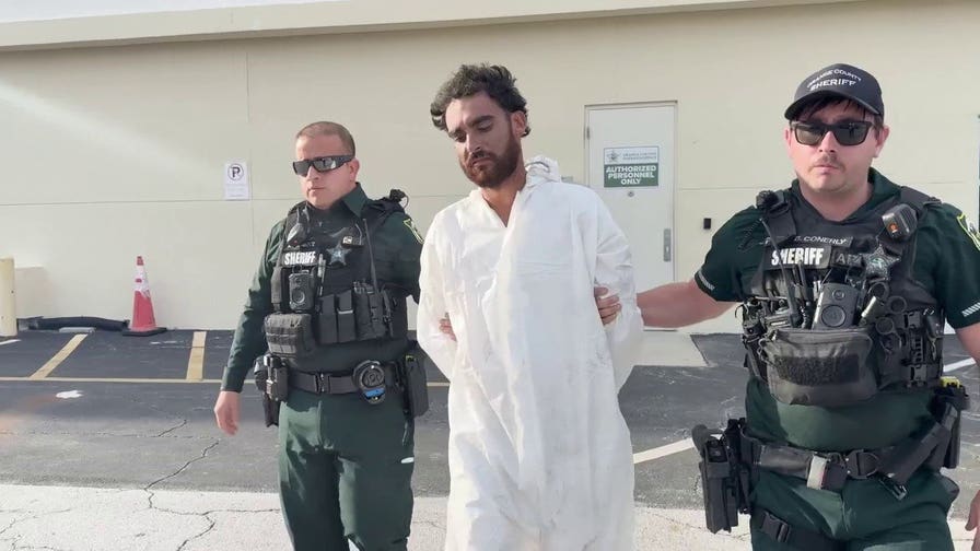 Raul Lionel Vazquez is escorted by sheriff's deputies after allegedly shooting a man running away from him