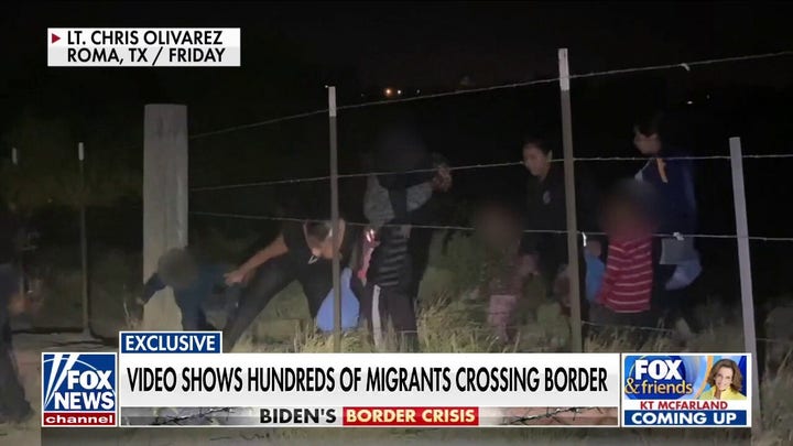 Exclusive video shows hundreds of migrants crossing southern border