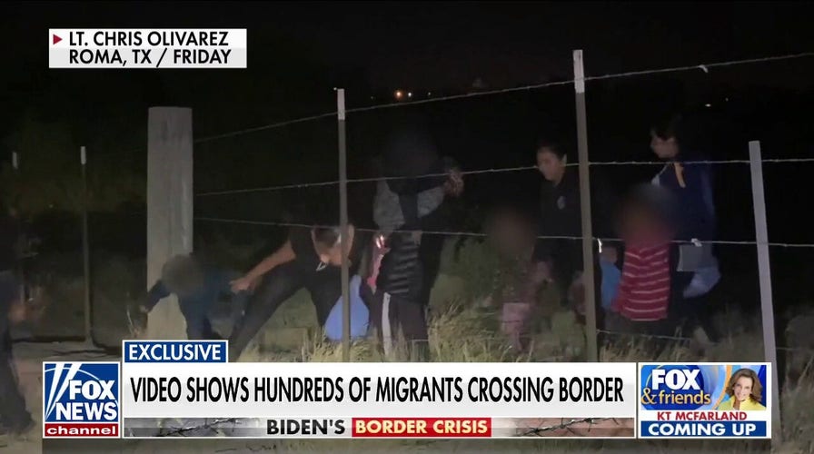 Exclusive video shows hundreds of migrants crossing southern border