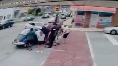 Bodycam footage shows bystanders, police lift car off e-bike rider trapped underneath