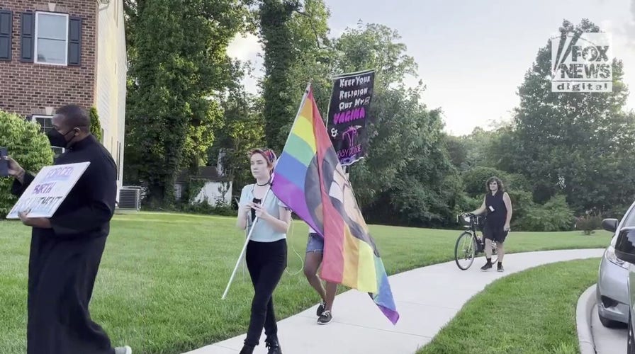 Protestors march outside of Supreme Court Justice Amy Coney Barrett's home