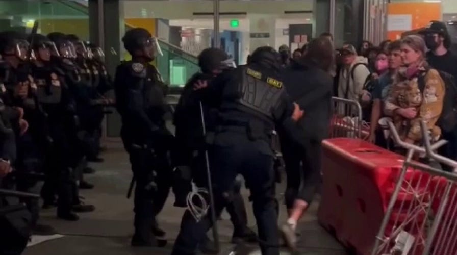 Agitator arrested extracurricular  Berkeley TPUSA lawsuit   aft  crossing barrier