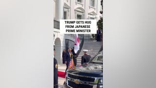 Trump hugs Japan's prime minister