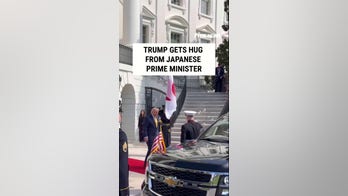 Trump hugs Japan's prime minister