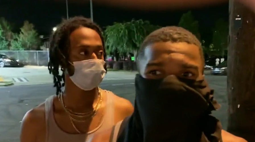 Armed men gather near Rayshard Brooks shooting site, say police are no longer allowed