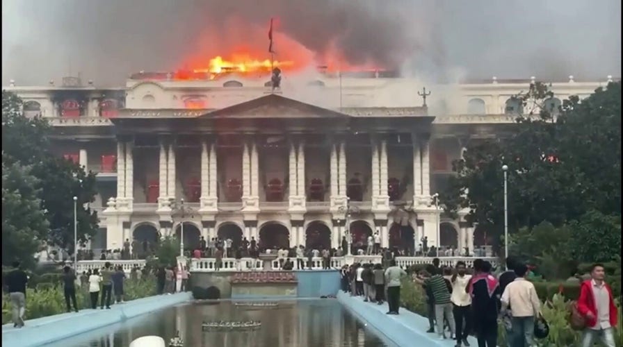 Nepal protests turn deadly as demonstrators storm parliament building and start fires