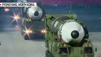 North Korea unveils new weapons at military parade