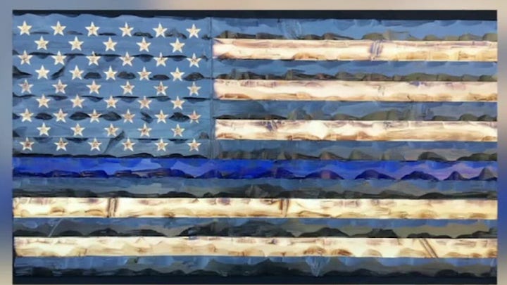 High school student raises $2,500 for veterans by making wooden American flags