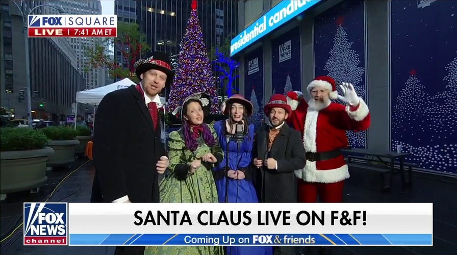 The Christmas Carolers perform 'Here Comes Santa Claus' on Fox Square