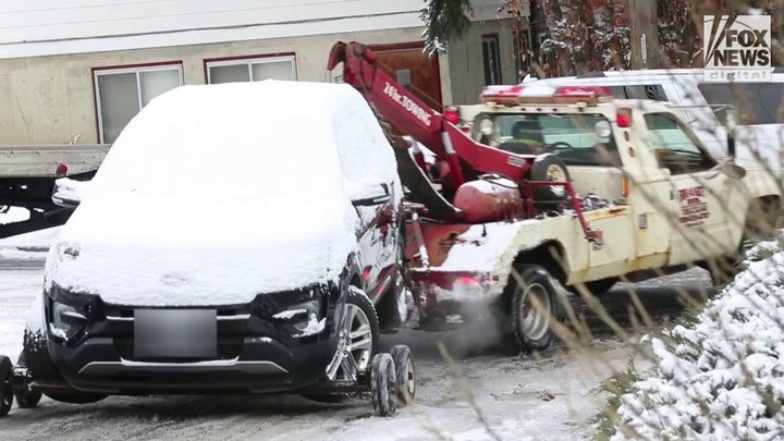 A car is towed away from crime scene in Moscow, Idaho