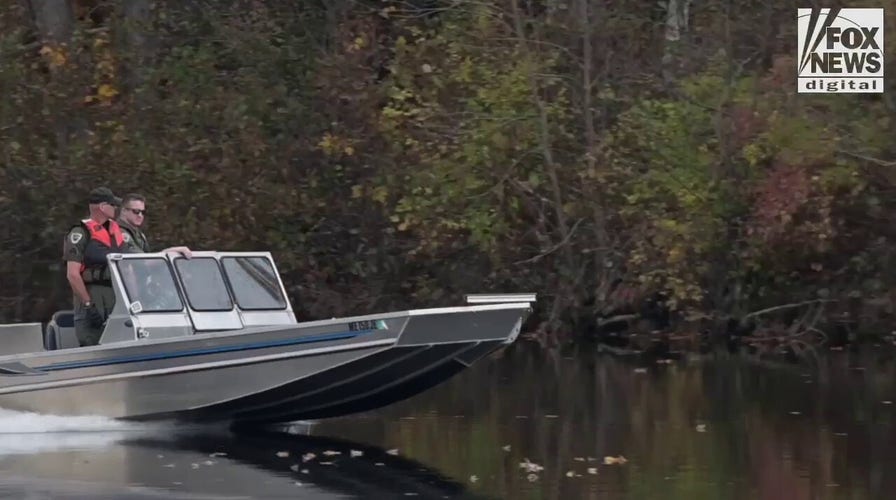 Law enforcement agents aid in the search for Robert Card along the Androscoggin River