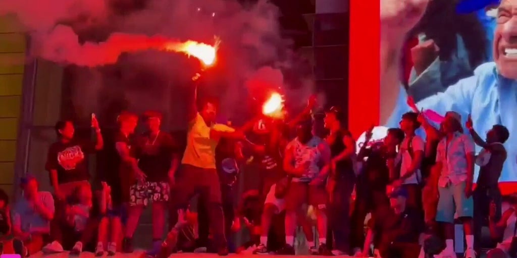 Knicks fans set off flares while standing on top of school bus