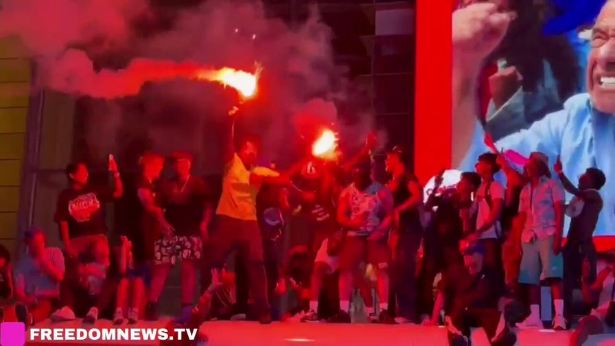 Knicks fans set off flares while standing on top of school bus