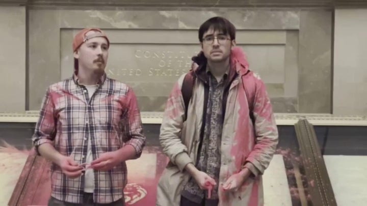 National Archives Rotunda evacuated after climate activists dump pink powder on case holding U.S. Constitution