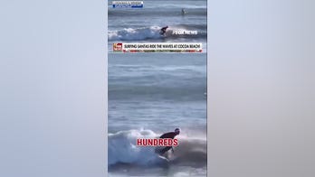 Hundreds of surfing Santas ride the waves in Cocoa Beach