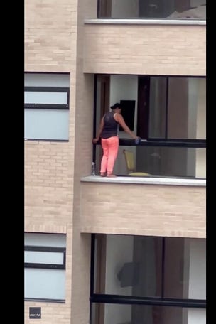 SEE IT: Woman stands on LEDGE to clean