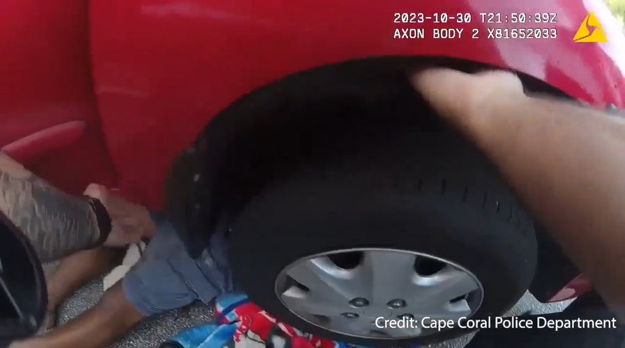 Florida police officers rush to aid of man stuck under car