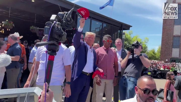 Former President Trump tosses MAGA hats to Iowa crowd
