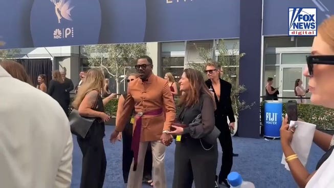 Colman Domingo chats with attendees while walking the 2026 Emmys red carpet