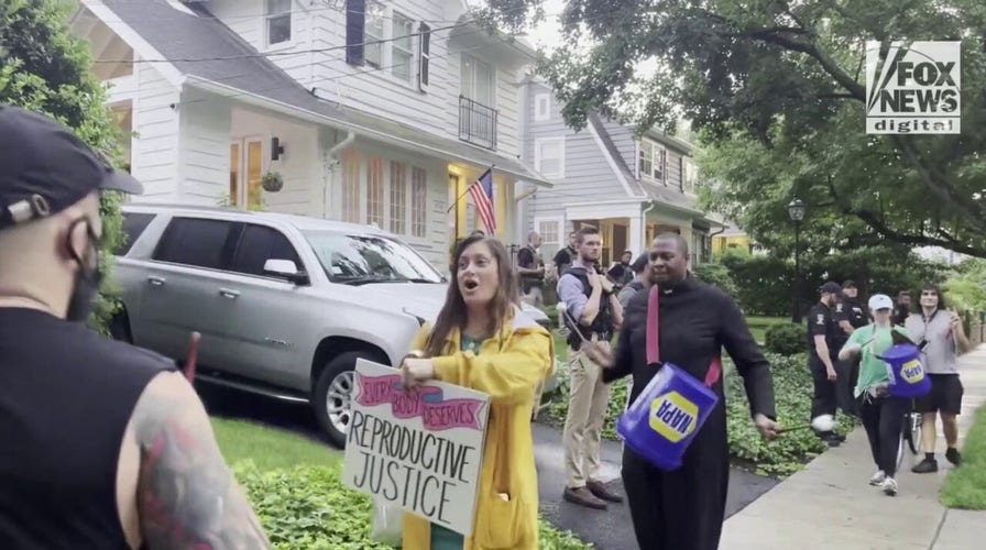 Protestors and drummers march outside of Supreme Court Justice Kavanaugh's house