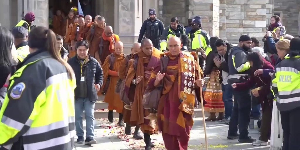 Bystanders gather to watch Buddhist monks complete 2,300-mile walk, cross into Washington, DC
