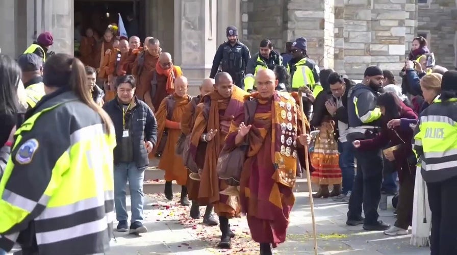 Bystanders gather to watch Buddhist monks complete 2,300-mile walk, cross into Washington, DC