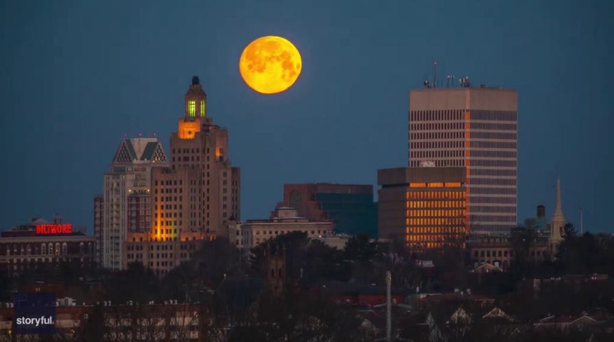 Orange moon sinks below Providence skyline in stunning time lapse footage