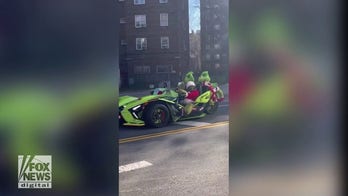 NYC Grinch car drives through Manhattan to celebrate Christmas