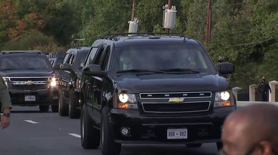 President Trump waves to supporters outside Walter Reed in motorcade