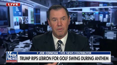 LeBron James practices his golf swing during national anthem