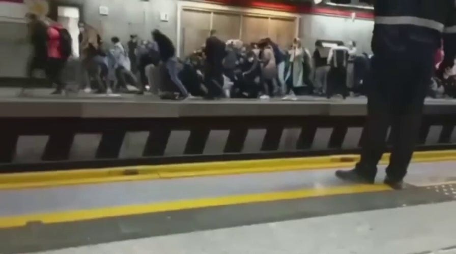 Iranian police attack protesters on subway