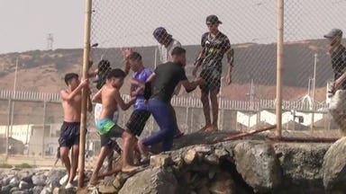 Migrants from Morocco pour over the border into Spain