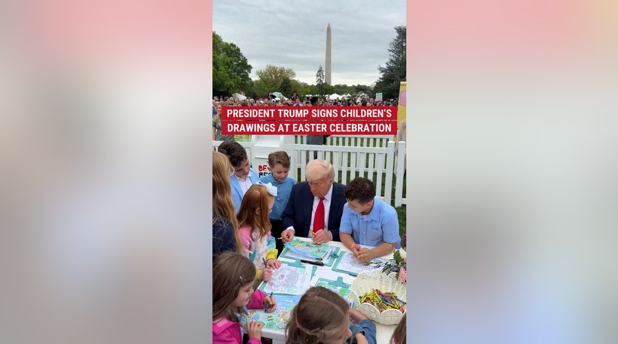 President Trump signs children's drawings at Easter celebration