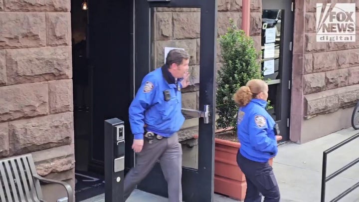 NYPD officers depart the AYH Hostel 