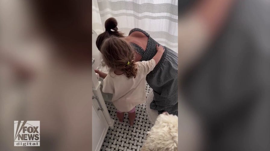 A toddler is seen comforting her pregnant mom who's been enduring months of morning sickness: See the sweet moment