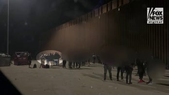 Migrants snap selfies at border after crossing into US