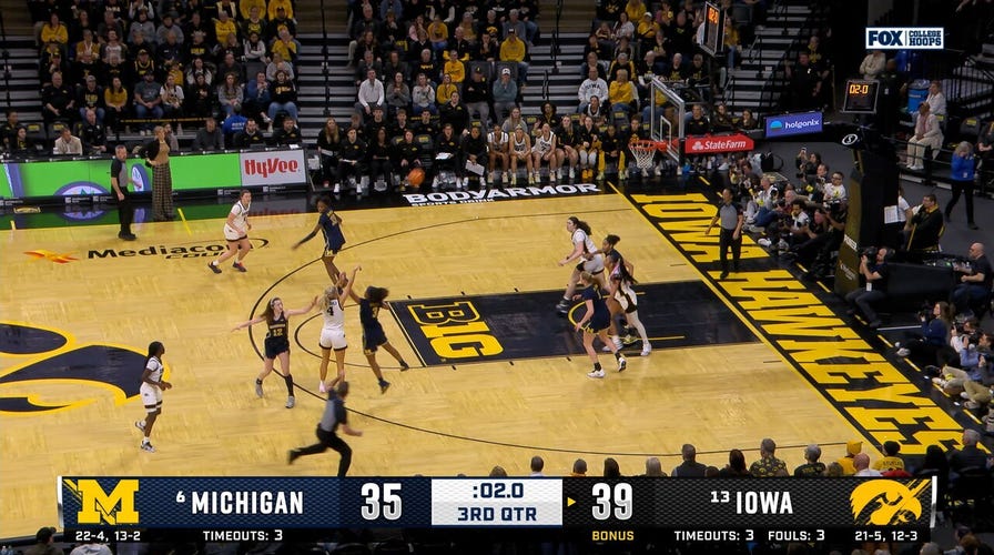 Kylie Feuerbach hits TOUGH step back three at the buzzer, extending Iowa's lead over Michigan 