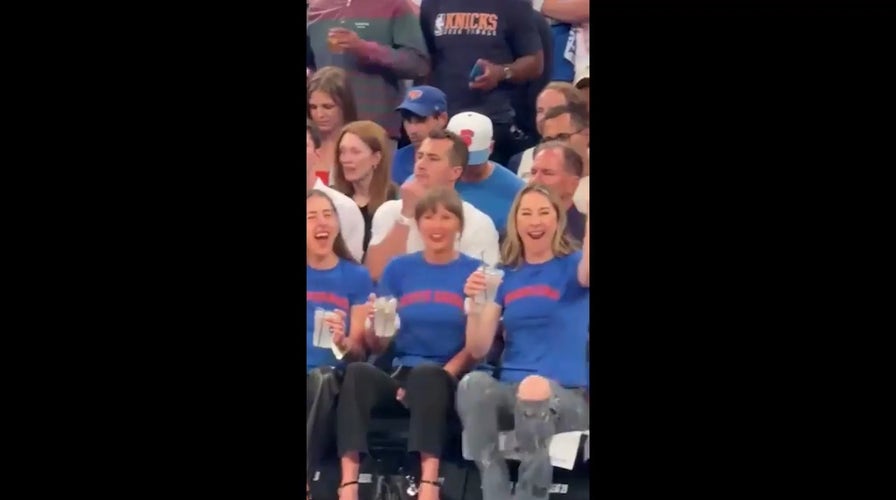 Taylor Swift cheers on Knicks courtside while sipping drink at showdown