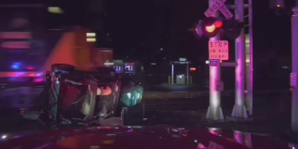 Michigan firefighters pull man to safety moments before train plows into overturned Jeep: video
