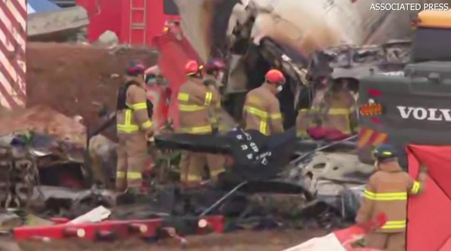 Rescuers seen pulling people out of plane following deadly crash at South Korean airport