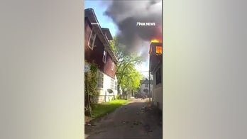 SEE IT: Officer catches baby thrown from burning house window