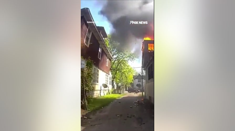 SEE IT: Officer catches baby thrown from burning house window