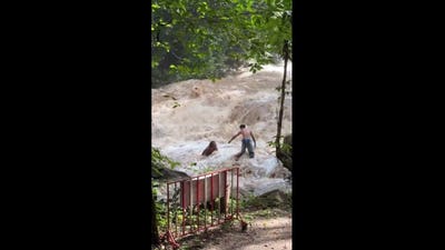 Terrifying moment tourists are swept away by sudden flood at Thai waterfall