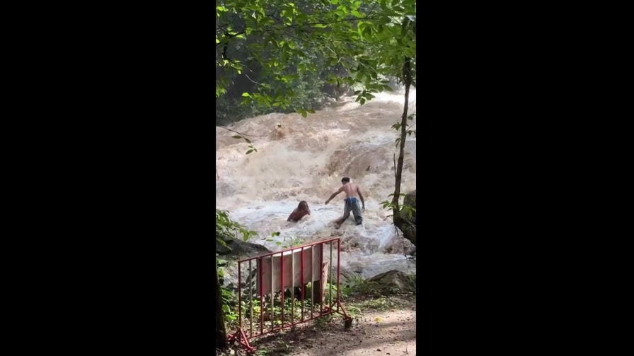 Terrifying moment tourists are swept away by sudden flood at Thai waterfall