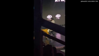 Machine Gun Kelly protected by security after fan storms stage